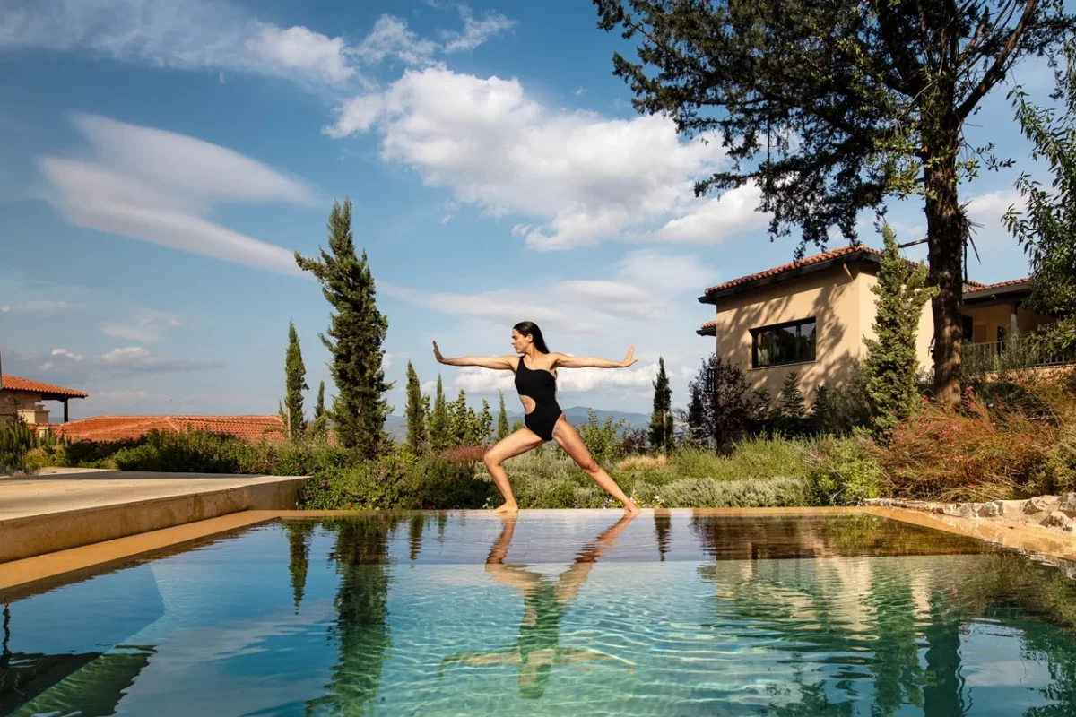 A guest exercises at the pool area of the Euphoria Retreat in Greece.